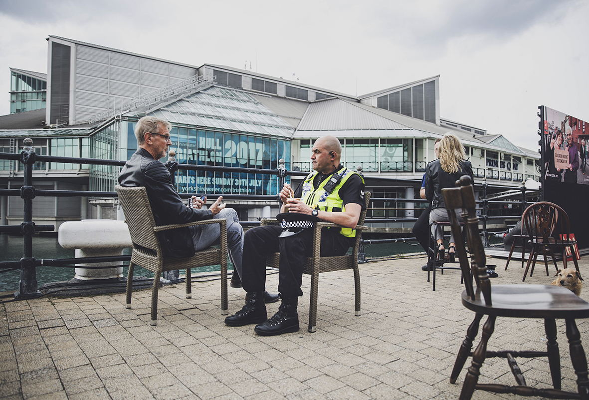 POLICE MAN HAVING A CONVERSATION WITH STRANGER WHILE HAVING SOUP ATSA PRINCESS DOCK STREET FREEDOM FESTIVAL 2017
